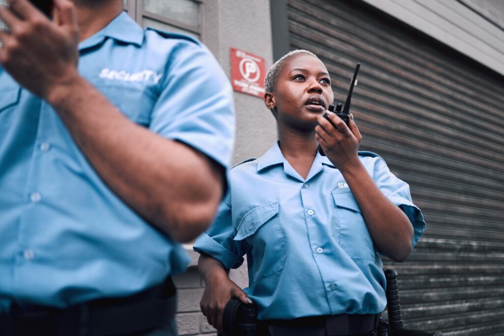 Security walkie talkie and a black woman police officer in the city during her patrol for safety o - The Security & Technology Digest Turjawali Satpam